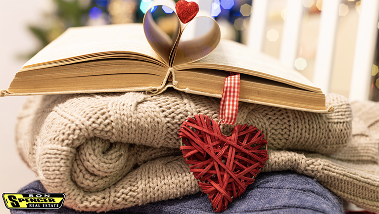 a stacked book with a red heart bookmark