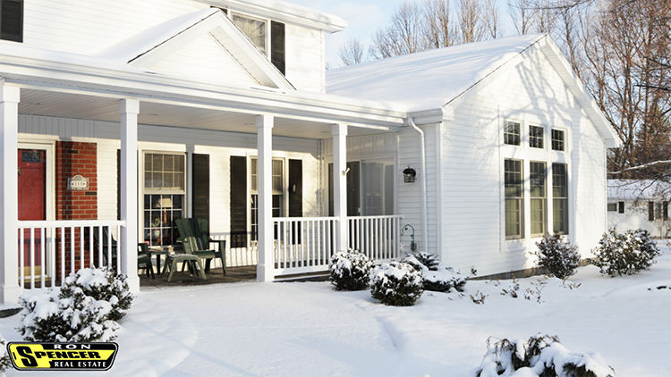 White cottage-style house with snow out front