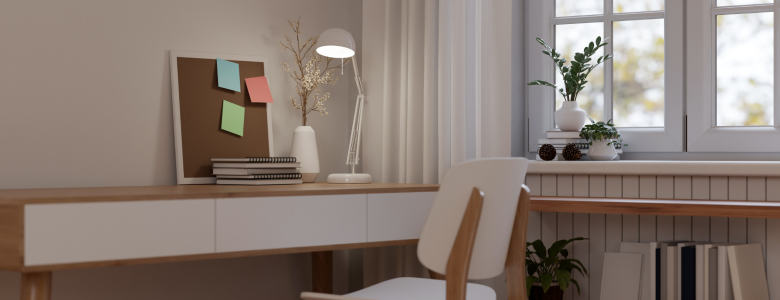 Desk and chair in a home office with a window and white curtain and a corkboard with post it notes and a white lamp