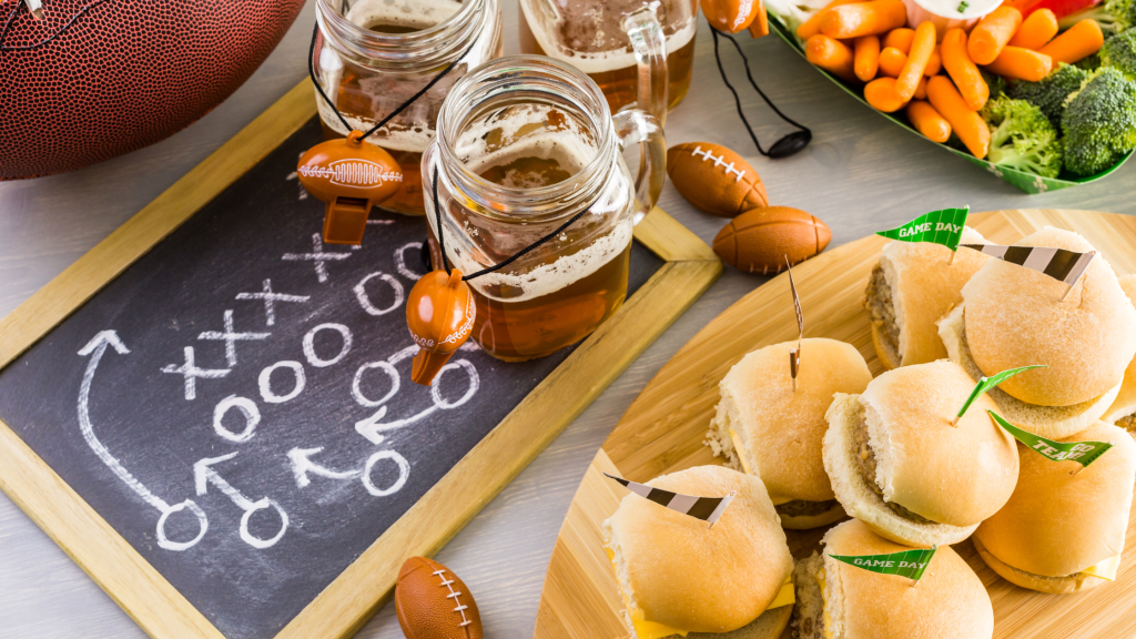 Display of game day food and a chalk board with a football play on it in chalk