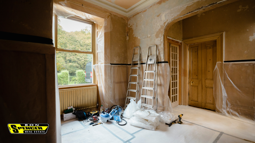 A home space interior with ladders and paint tarps for a home renovation