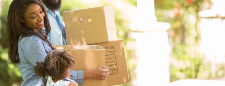 African American Family carrying boxes for a house move