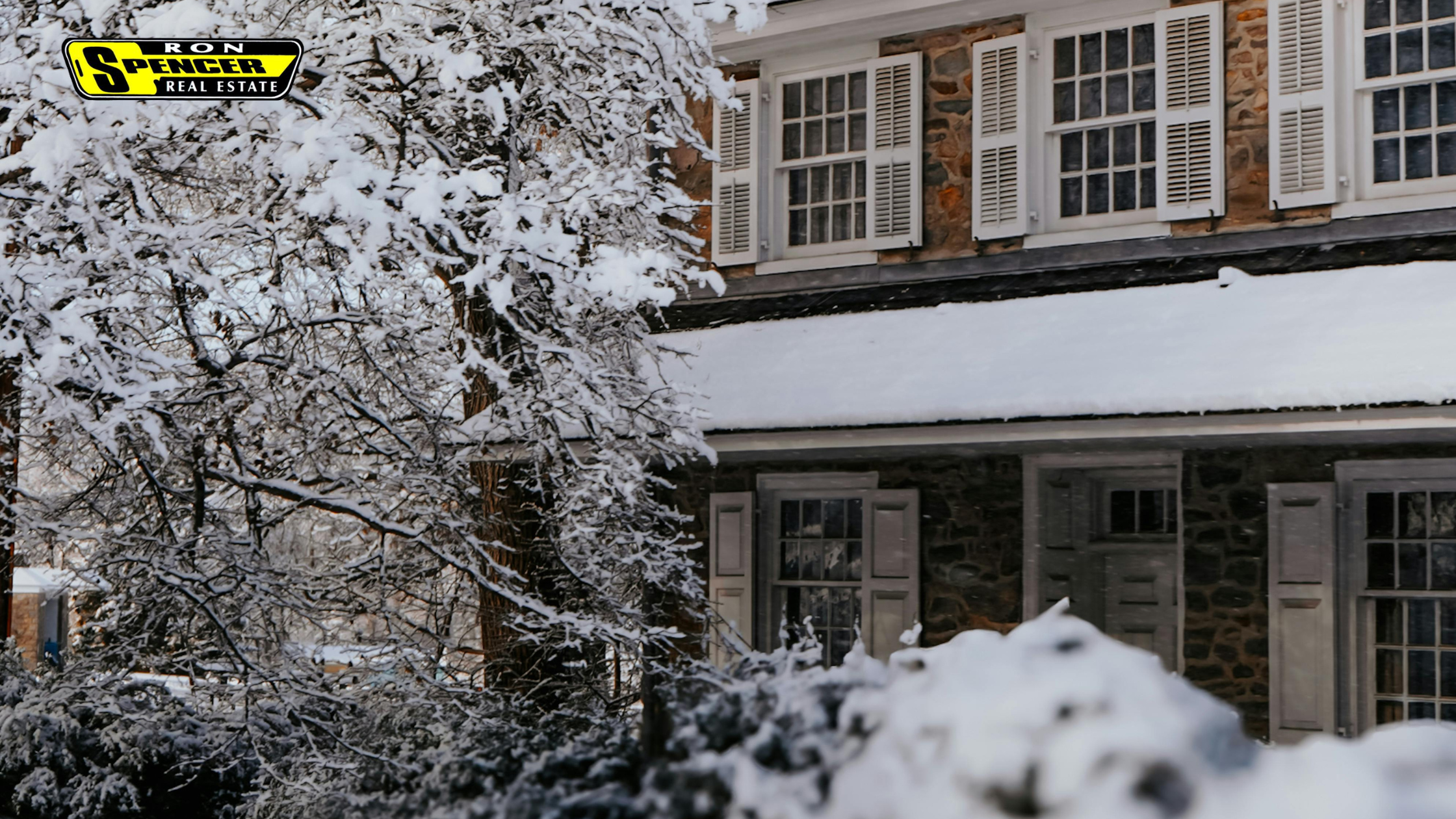 brick home covered in snow in the winter