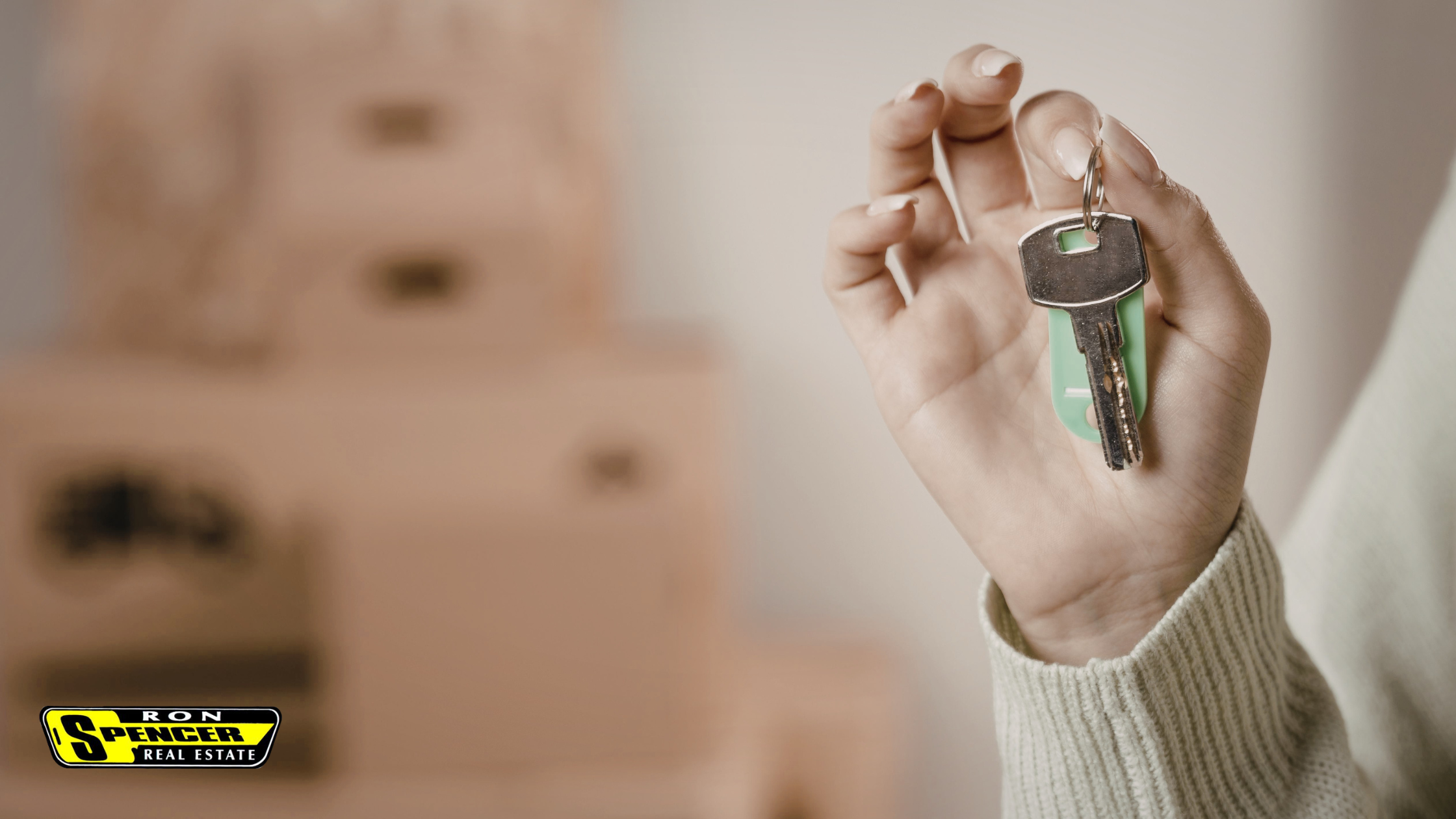 Caucasian hand holding a set of house keys