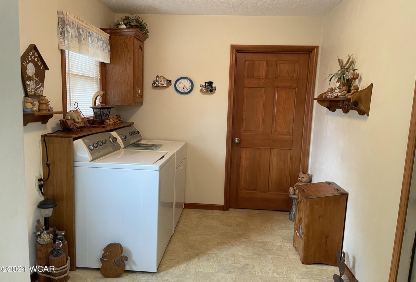 Laundry room is conveniently located off the rear door and easily accessible to the rest of the house.