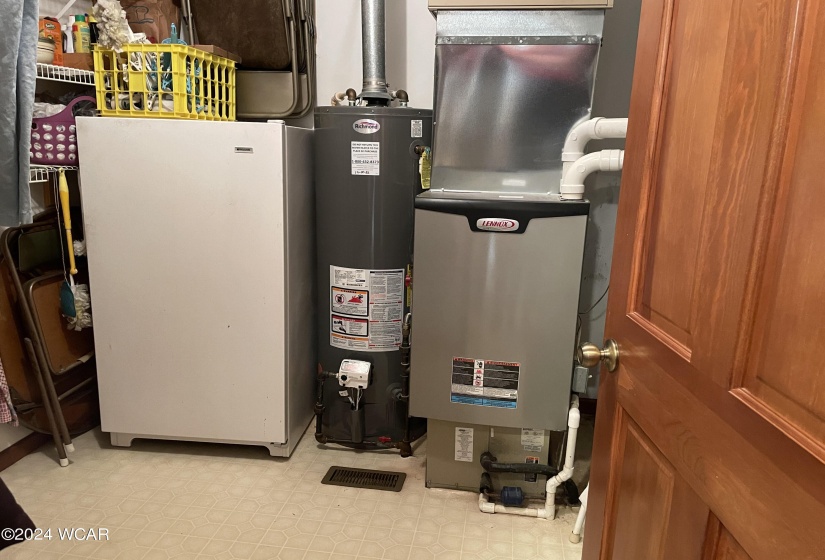 A separate storage room features additional shelving, houses a place for your freezer, gas hot water heater and gas furnace.