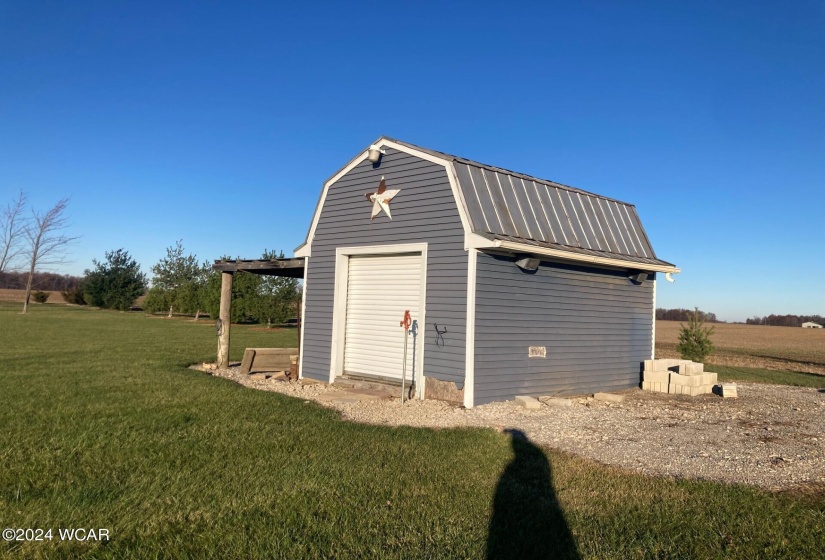 Shed with a frost proof spigot and covered storage area