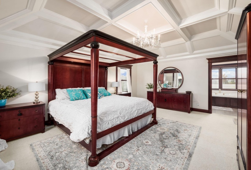 Primary bedroom w/ coffered ceilings