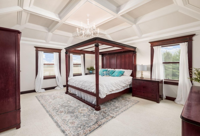 Primary bedroom w/ coffered ceilings