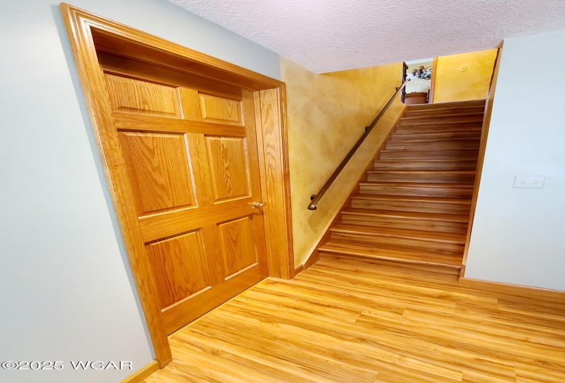 Towards potential third bedroom and steps leading back up to the Living room.
