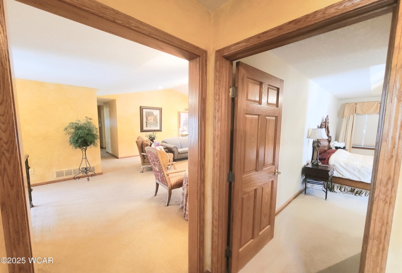 Living room on the left, primary bedroom on the right