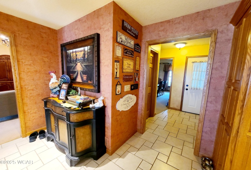 Kitchen towards one of two half baths and the garage and formal dining room.