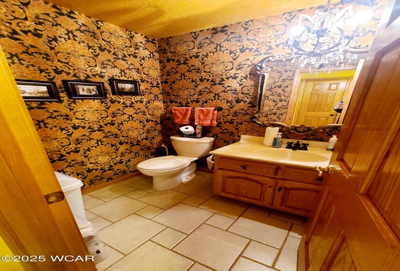 Half bath near laundry room and garage.