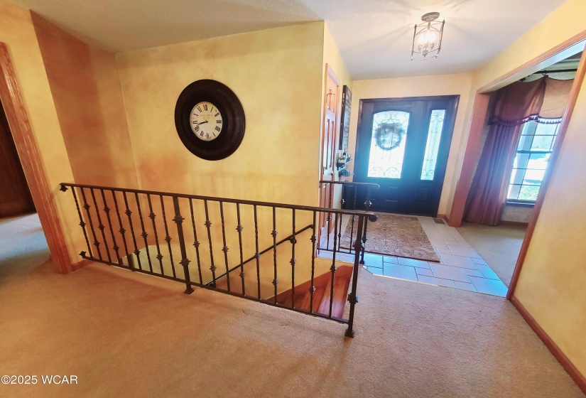 Towards basement and front door and formal dining room.