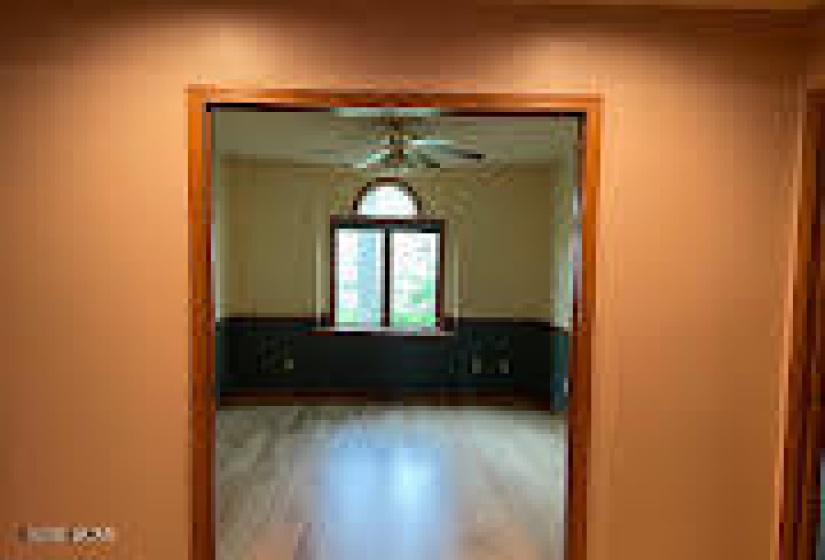 Den with hardwood flooring
