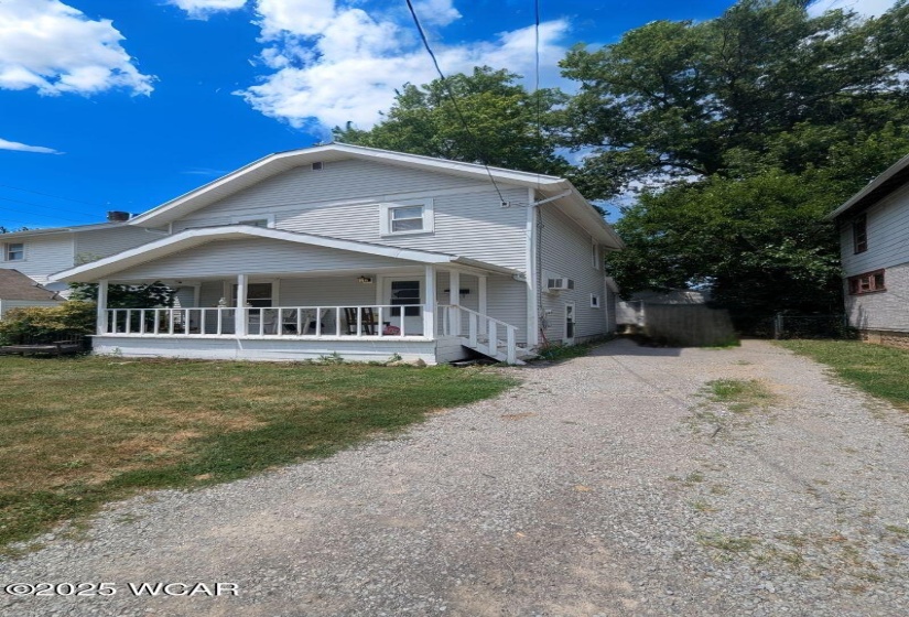 This property features a spacious driveway, street parking, and one and a half detached garage.
