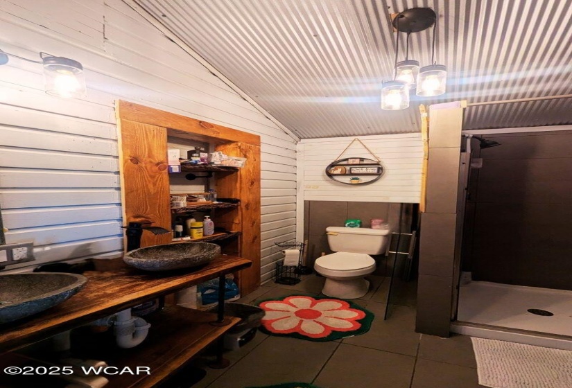 Primary suite on main floor with dual sinks, step in shower, and walk-in closet.