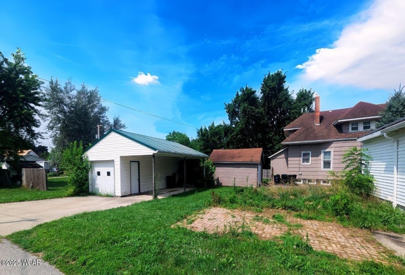 Detached two car garage with carport for plenty of storage for your vehicles or tools!